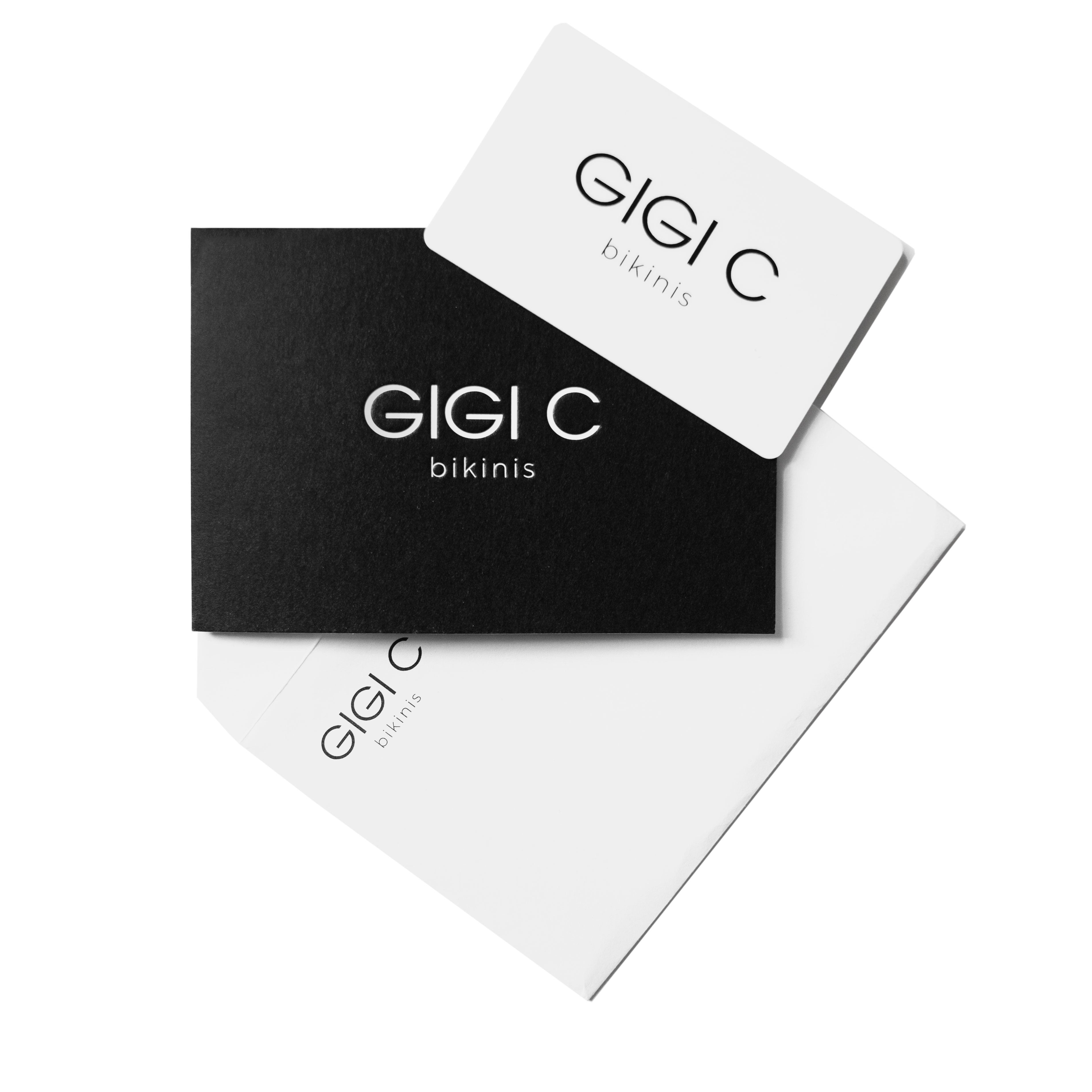 A chic Gift Card from Gigi C featuring a stylish black and white design. The black card with bold white lettering artistically overlays the elegant white card beneath, making it an ideal sophisticated gift choice.